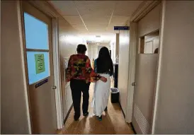  ?? REBECCA BLACKWELL/AP ?? A 33-year-old mother of three from central Texas is escorted by clinic administra­tor Kathaleen Pittman prior to getting an abortion Oct. 9 at Hope Medical Group for Women in Shreveport, La.