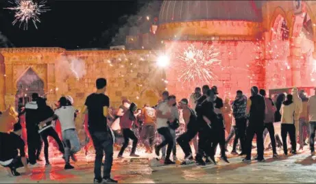  ?? AFP ?? Stun grenades burst in the air amid clashes between Palestinia­n protesters and Israeli security forces at the Al-aqsa mosque compound in Jerusalem.