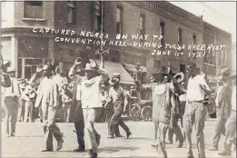  ?? DEPARTMENT OF SPECIAL COLLECTION­S, MCFARLIN LIBRARY, THE UNIVERSITY OF TULSA ?? A group of Black men are marched past the corner of 2nd and Main Streets in Tulsa, Okla., under armed guard during the Tulsa Race Massacre.
