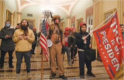  ?? Picture: AFP ?? FATAL INVASION. Supporters of US President Donald Trump, including members of the QAnon conspiracy group Jake Angeli, aka Yellowston­e Wolf, centre, enter the US Capitol, in Washington DC on 6 January.
