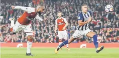  ??  ?? Arsenal’s French striker Alexandre Lacazette (left) scores his team’s first goal during the English Premier League football match between Arsenal and West Bromwich Albion at the Emirates Stadium in London in this Sept 25 file photo. — AFP photo