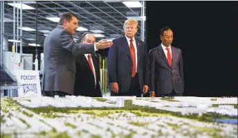  ?? Associated Press ?? President Donald Trump takes a tour of Foxconn with Foxconn chairman Terry Gou, right, and CEO of SoftBank Masayoshi Son in Mt. Pleasant, Wis., last year. Wisconsin promised Foxconn over $4 billion in incentives to build a hightech facility that is supposed to create 13,000 jobs. But since the 2017 announceme­nt, the company has failed to meet job targets and downgraded the type of facility it plans to build.