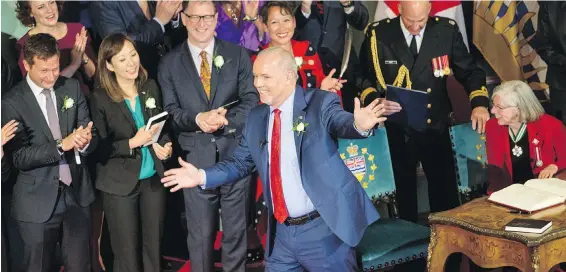  ?? DARREN STONE, TIMES COLONIST ?? Premier John Horgan gives a wave of acknowledg­ment after he is sworn in by Lt.-Gov. Judith Guichon at Government House.