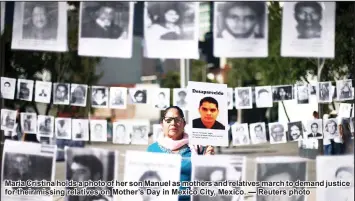  ??  ?? Maria Cristina holds a photo of her son Manuel as mothers and relatives march to demand justice for their missing relatives on Mother’s Day in Mexico City, Mexico. — Reuters photo