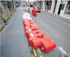  ??  ?? The toppled barriers on Church Street in St Andrews.