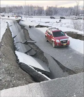  ?? Ryan Marlow/Alaska Aerial Media / TNS ?? A road in Anchorage collapsed Saturday after a strong earthquake shook south central Alaska on Friday. The magnitude 7.0 earthquake hit the Kenai Peninsula and the Cook Inlet.