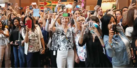  ??  ?? Warm welcome: Admirers gather outside yesterday’s symposium to snatch a glimpse – and a photo – of Prince Harry