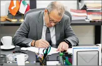  ?? ?? Gebran Bassil, a prominent Lebanese legislator who heads the main Christian group allied with Hezbollah, working on his desk before an interview with the Associated Press, in Beirut, Lebanon, Monday, Oct 17, 2022. (AP)