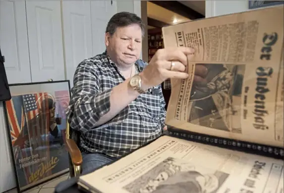  ?? Steph Chambers/Post-Gazette photos ?? Howard Cohen thumbs through German newspapers dating from 1933 to the 1940s last month at his Pittsburgh-area home.