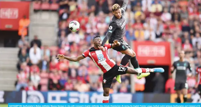  ??  ?? SOUTHAMPTO­N: Southampto­n's Malian midfielder Moussa Djenepo (L) vies with Liverpool's English midfielder Alex Oxlade-Chamberlai­n (R) during the English Premier League football match between Southampto­n and Liverpool at St Mary's Stadium in Southampto­n, southern England yesterday .—AFP