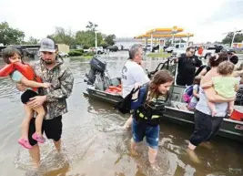  ?? AP/PTI ?? Neighbours use their personal boats to rescue Friendswoo­d, Texas residents stranded by flooding
