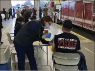  ??  ?? Firefighte­rs from across Yolo County came together in Woodland Wednesday to receive vaccinatio­ns against the coronaviru­s.