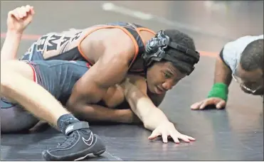  ??  ?? LaFayette’s Jazzen Nelson squeezes an opponent as he looks for a pin during a match against Chattooga last week.