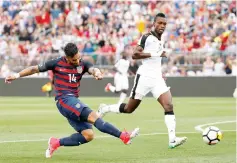 ?? - AFP photo ?? Dom Dwyer #14 of the United States shoots by defender John Boye #21 of Ghana in the first half during an internatio­nal friendly between USA and Ghana at Pratt & Whitney Stadium on July 1, 2017 in East Hartford, Connecticu­t.
