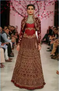  ?? AP and supplied photos ?? Bollywood actress Kangana Ranaut (centre) displays a creation by Indian designer Manav Gangwani at the India Couture Week 2016, in New Delhi, on Sunday. The two other models walk the ramp with the creations designed by Rohit Bal. —