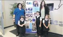  ?? WIL ANDRUSCHAK ?? On the left, Malka Labell and Mira, 4, with Jennifer Hadley and Joseph, 6, and Ella, 5, at the Calgary Jewish Academy.