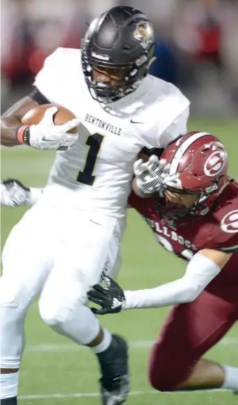  ?? NWA DEMOCRAT-GAZETTE FILE PHOTO ?? Preston Crawford tries to pull away from a Springdale High defender on a running play. The Tigers won the 7A-West Conference championsh­ip and earned a first-round bye in the Class 7A state playoffs.