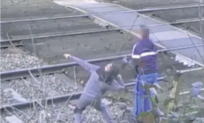  ??  ?? ●●This still from footage issued by British Transport Police shows young boys throwing stones at high voltage power cables overhead