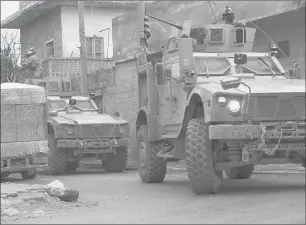  ?? GETTY-AFP ?? An image taken from a video obtained by AFPTV on Wednesday shows U.S. armored vehicles at the scene of a suicide attack in the northern Syrian town of Manbij. Four Americans were killed.