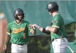  ?? PETE BANNAN - MEDIANEWS GROUP ?? Zach Tropiano gets a fist bump from Pat Toal after scoring in in the first inning for the Drexel Hill Ducks against the Springfiel­d Colonials in Delco League action Wednesday.