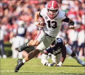  ?? Butch Dill / Associated Press ?? Georgia quarterbac­k Stetson Bennett carries the ball against Auburn on Oct. 9.