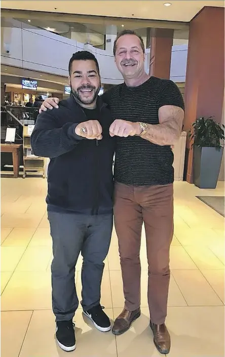  ??  ?? Ex-Eskimo Milson Jones’ son, Devon, left, displays his father’s 1987 Grey Cup ring alongside Ottawa businessma­n Walter Pamic, who bought the ring at an auction in the mid-1990s and wanted to return it to Jones at no cost.