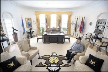  ?? PHOTOS BY JERRY HOLT / MINNEAPOLI­S STAR TRIBUNE ?? Glynn A. Crooks, a former tribal leader and member of the Shakopee Mdewakanto­n Sioux, sits in his full-scale replica of the White House Oval office at his home Prior Lake, Minn.