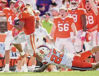  ?? Eakin Howard/Getty Images ?? Clemson’s Will Shipley evades a tackle attempt by Syracuse’s Justin Barron before scoring a touchdown in the fourth quarter. Shipley scored twice and gained a career-high 172 yards.