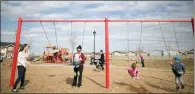  ?? NOEL WEST / THE NEW YORK TIMES ?? Children and women gather on a playground. According to a study in 2018, women in the U.S. who have their first child before 25 or after 35 eventually close the salary divide with their husbands. It’s the years in between that are most problemati­c,...