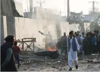  ?? (Omar Sobhani/Reuters) ?? AFGHAN PROTESTERS burn tires and shout slogans at the site of a blast in Kabul on Tuesday.