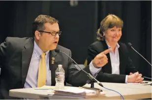  ?? BY DOUG STROUD FOR THE FAUQUIER TIMES ?? Republican Tom Garrett Jr. and Democrat Jane Dittmar react at Monday night's 5th Congressio­nal District candidates' debate in Warrenton.