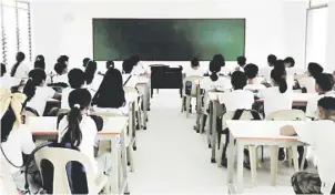  ?? PHOTOGRAPH COURTESY OF TEAM ENERGY FOUNDATION ?? STUDENTS waiting for their face-to-face classes to begin at the newly constructe­d school building donated by TeaM Energy Foundation in Sioasio Integrated School in Sual, Pangasinan.