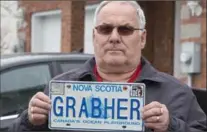  ?? ANDREW VAUGHAN, THE CANADIAN PRESS ?? Lorne Grabher displays his personaliz­ed licence plate in Dartmouth, N.S., on Friday. The Nova Scotia government has withdrawn the licence plate, saying his surname is offensive to women.