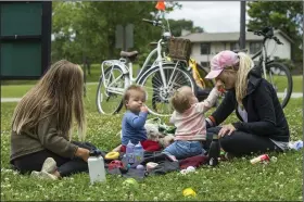  ?? (NWA Democrat-Gazette/Ben Goff) ?? Sarah Schutte (from left), 1-year-old twins Knox Breeden and Kennedy Breeden, and Mallory Breeden, all of Bentonvill­e, take a break Wednesday at Horsebarn Trailhead Park in Rogers during a bike ride on the hard-surface trails. More photos at arkansason­line.com/614greenwa­y/.