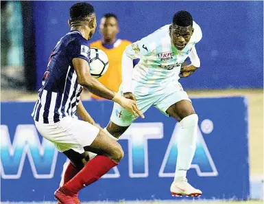  ??  ?? Chantomoi Taylor (right) of St George’s College tries to go past Nathan Hunter of Jamaica College in the semi-final of the Manning Cup in 2018.