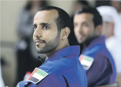  ?? Pawan Singh / The National ?? Above, Maj Hazza Al Mansouri and Sultan Al Neyadi during a press conference at Dubai Media Office. Left, Maj Al Mansouri on board the Internatio­nal Space Station