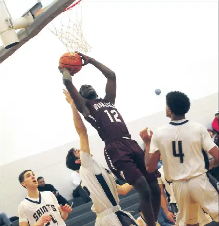  ?? Photo by Ernest A. Brown ?? The Woonsocket boys basketball team played great defense according to coach T.J. Cilofi to dominate St. Raphael 77-61 in a Division I-North clash Tuesday. At one point in the second half, the Villa Novans led by 30 points.