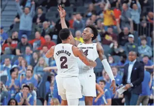  ??  ?? Arizona State's Rob Edwards and Kimani Lawrence celebrate after Lawrence made a 3-pointer against UCLA in a Pac-12 tournament quarterfin­al on Thursday in Las Vegas.