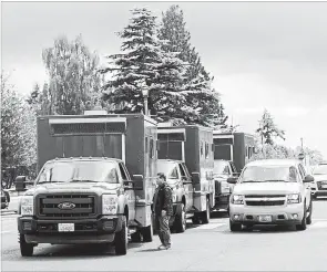  ?? REBEKAH WELCH THE ASSOCIATED PRESS ?? Washington State Department of Natural Resources trucks wait to board a ferry to Ketron Island, Saturday, Aug. 11, where a stolen commercial plane crashed.