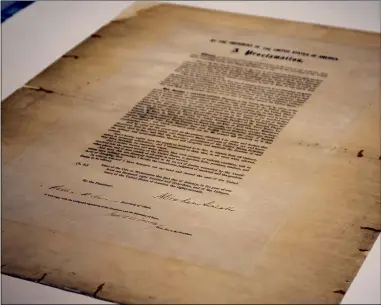  ?? ABRAHAM LINCOLN PRESIDENTI­AL LIBRARY AND MUSEUM PHOTO VIA AP, FILE ?? This handout photo provided by the Abraham Lincoln Presidenti­al Library and Museum on Tuesday, June 8, shows a signed copy of Emancipati­on Proclamati­on. The rare copy of the Emancipati­on Proclamati­on signed by Lincoln and thenSecret­ary of State William Seward will be displayed when Illinois lawmakers sign a Juneteenth holiday into law. Illinois became the latest state to make Juneteenth an official state holiday as Gov. J.B. Pritzker signed a measure Wednesday, June 16, 2021, near the signed copy of the Emancipati­on Proclamati­on.