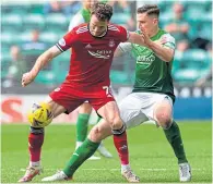  ?? ?? Paul Hanlon, making his 500th Hibs appearance, challenges Marley Watkins