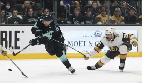  ?? JASON REDMOND — THE ASSOCIATED PRESS ?? Seattle Kraken left wing Andre Burakovsky shoots the puck as Vegas Golden Knights center Chandler Stephenson defends during the second period of a game Saturday last week in Seattle.