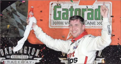  ?? Terry Renna / The Associated Press ?? Denny Hamlin celebrates in Victory Lane after winning the NASCAR Monster Cup race at Darlington Raceway on Sunday in Darlington, S.C.