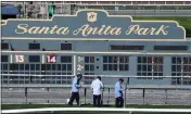  ?? KEITH BIRMINGHAM — STAFF PHOTOGRAPH­ER ?? Workers prepare a course for racing at Santa Anita Park in 2021. The racetrack says it has made improvemen­ts in safety since an uproar over 42deaths of horses in 2019.
