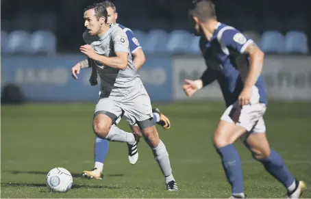  ??  ?? Ex-Sunderland left-back Blair Adams (grey strip) makes a surging run in Hartlepool United’s 1-1 draw at Macclesfie­ld last night.