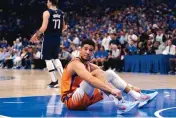  ?? TONY GUTIERREZ/ASSOCIATED PRESS ?? Phoenix Suns guard Devin Booker (1) looks up at an official after being knocked to the floor in Sunday’s Game 4 against the Dallas Mavericks in Dallas.