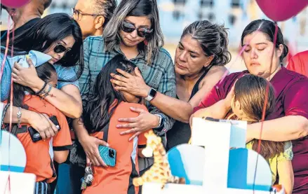  ?? CHANDAN KHANNA/GETTY-AFP ?? Teammates of Tess Mata, who died in the shooting, are comforted by their mothers while at a memorial May 26 in Uvalde, Texas.