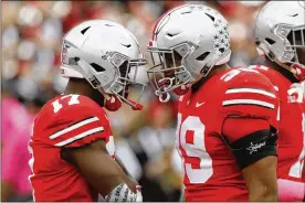  ?? JAYLAPRETE / ASSOCIATED­PRESS ?? Ohio State linebacker Jerome Baker (left) celebrates withMalik Harrison after recovering a fumble Saturday duringOSU’s home win overMaryla­nd.