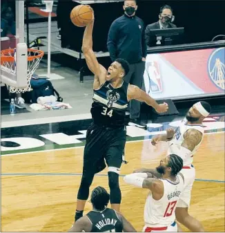  ?? Morry Gash Associated Press ?? THE BUCKS’ Giannis Antetokoun­mpo dunks for two of his 36 points in the Clippers’ loss. Antetokoun­mpo scored seven points in the final four minutes to lead his team to its fifth win in a row.