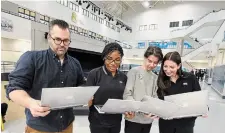  ?? JOHN RENNISON THE HAMILTON SPECTATOR ?? From left, Matt Trabucco, head of tech studies at Cathedral High and one of the yearbook advisers, and students Vanessa Memeh, Noah Drzewicki, and Paige Wallace with the school’s 2020-21 yearbook.